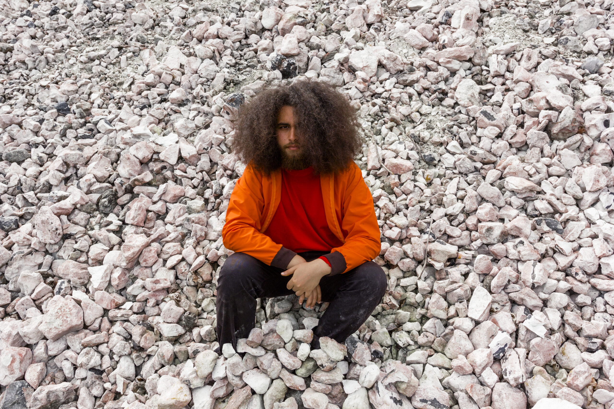 Cassius Lambert sitting on limestones in a limestone quarry.