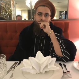 Cassius Lambert in a restaurant and looking in to the camera.