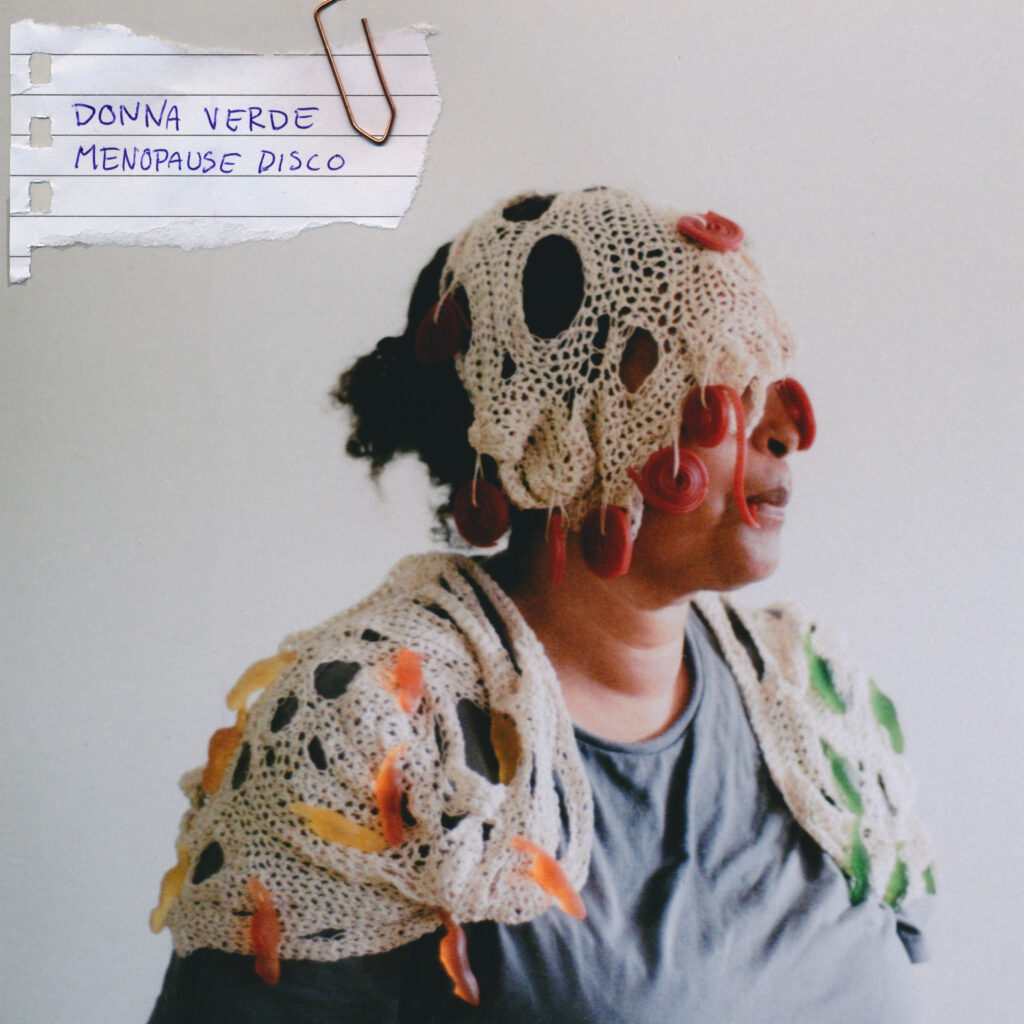 Cover of the Album Disco Menopause. Picture of woman with candy-art wrapped around herself. 
